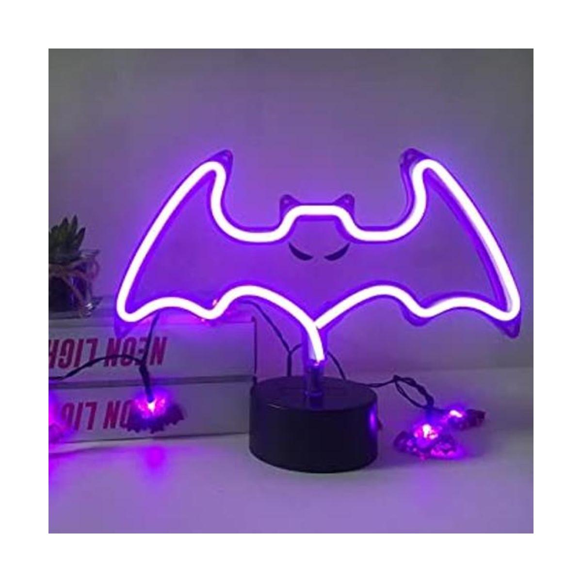 Letrero de neón con forma de murciélago morado luz de