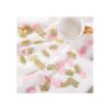 Confeti de corona con purpurina rosa y dorado una mesa de