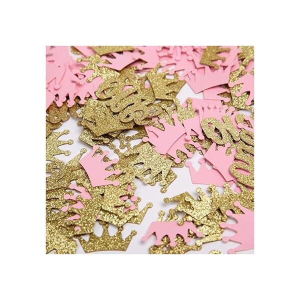 Confeti de corona con purpurina rosa y dorado una mesa de