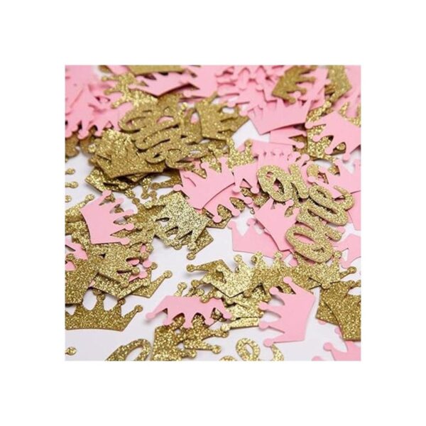 Confeti de corona con purpurina rosa y dorado una mesa de