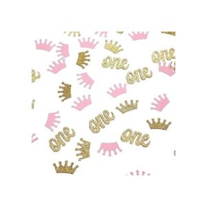 Confeti de corona con purpurina rosa y dorado una mesa de